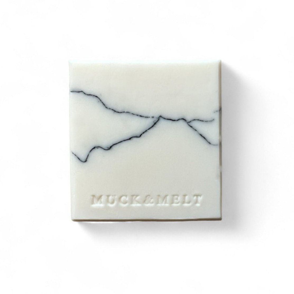 Bold handmade soap with black and grey strata patterns, inspired by rock formations
