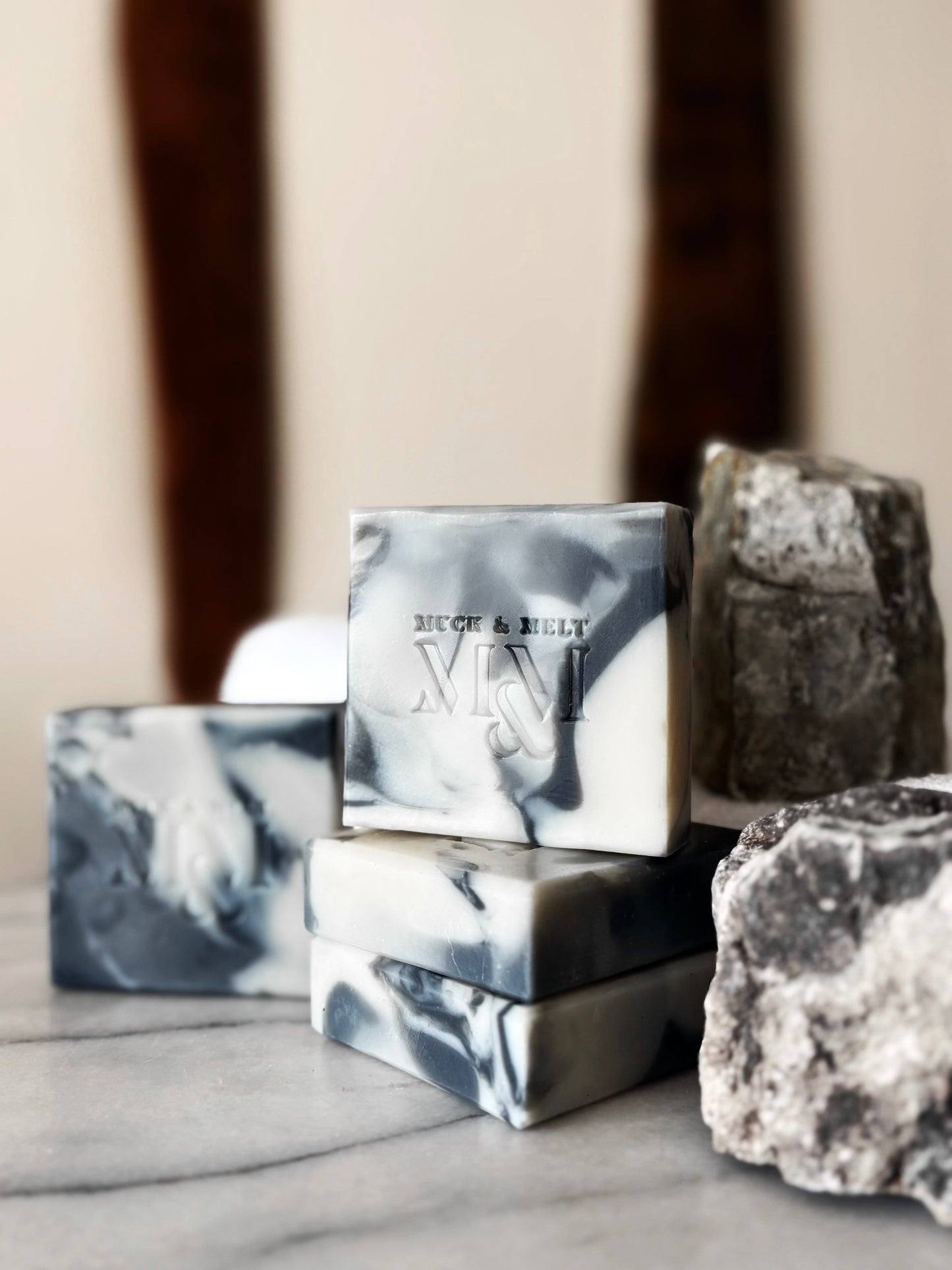 Handmade, natural artisan soap with rugged stone and marble inspired patterns in earthy tones