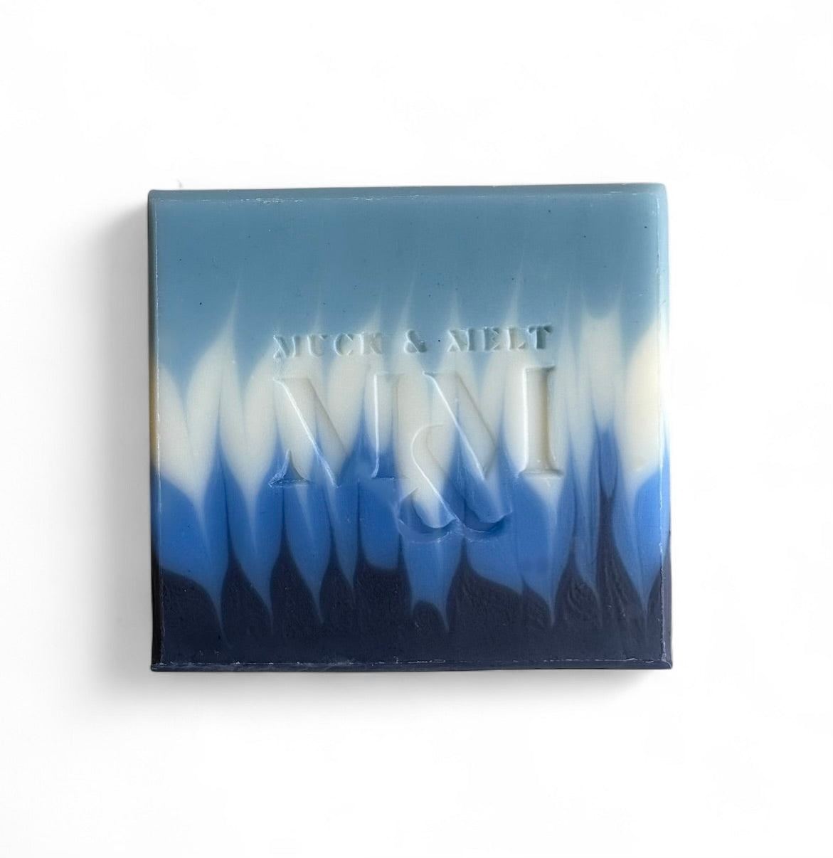 Ocean-inspired natural soap with deep blues and seafoam wave design