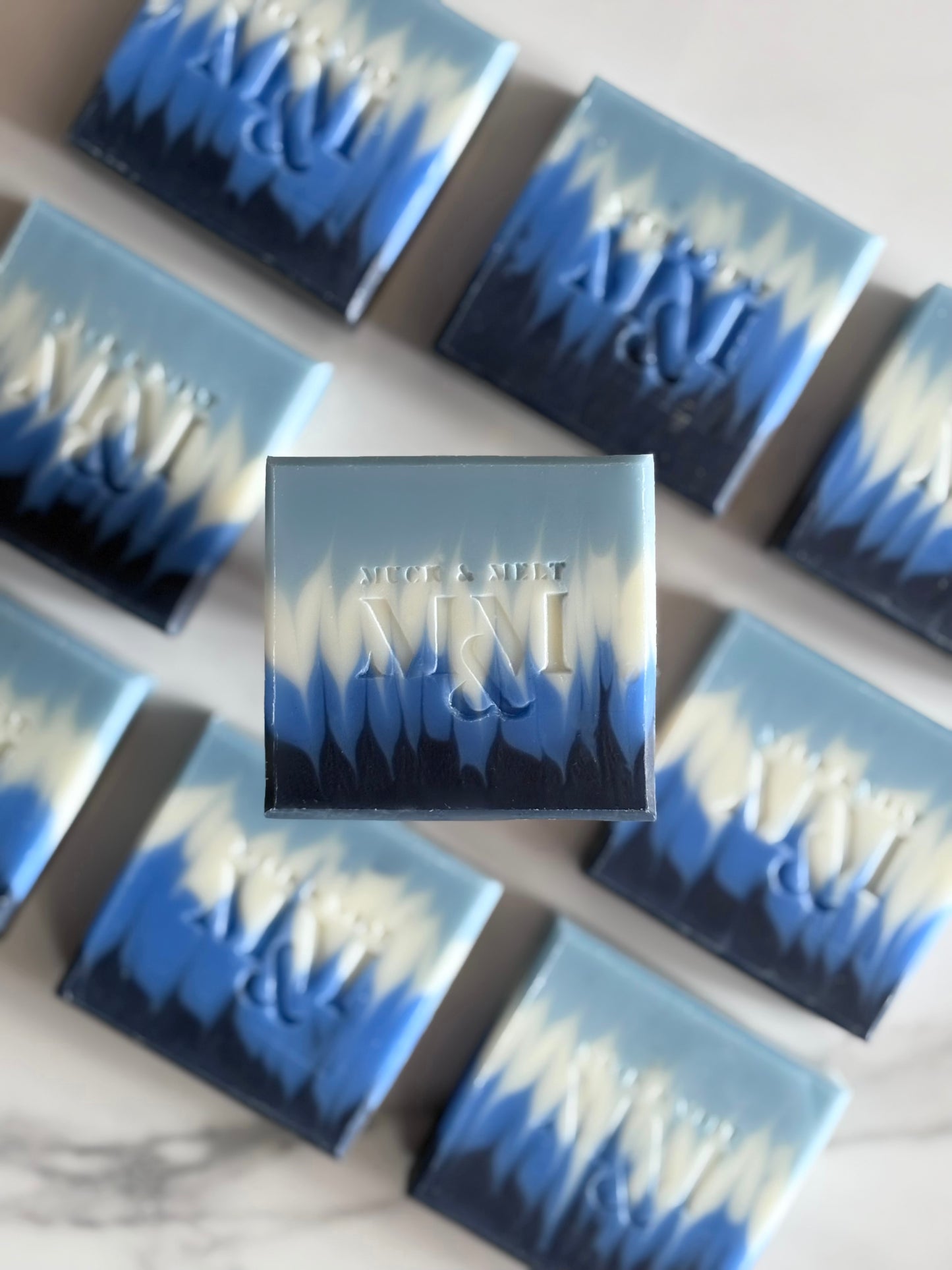 close up Ocean-inspired, handmade, natural soap with deep blues and seafoam wave design
