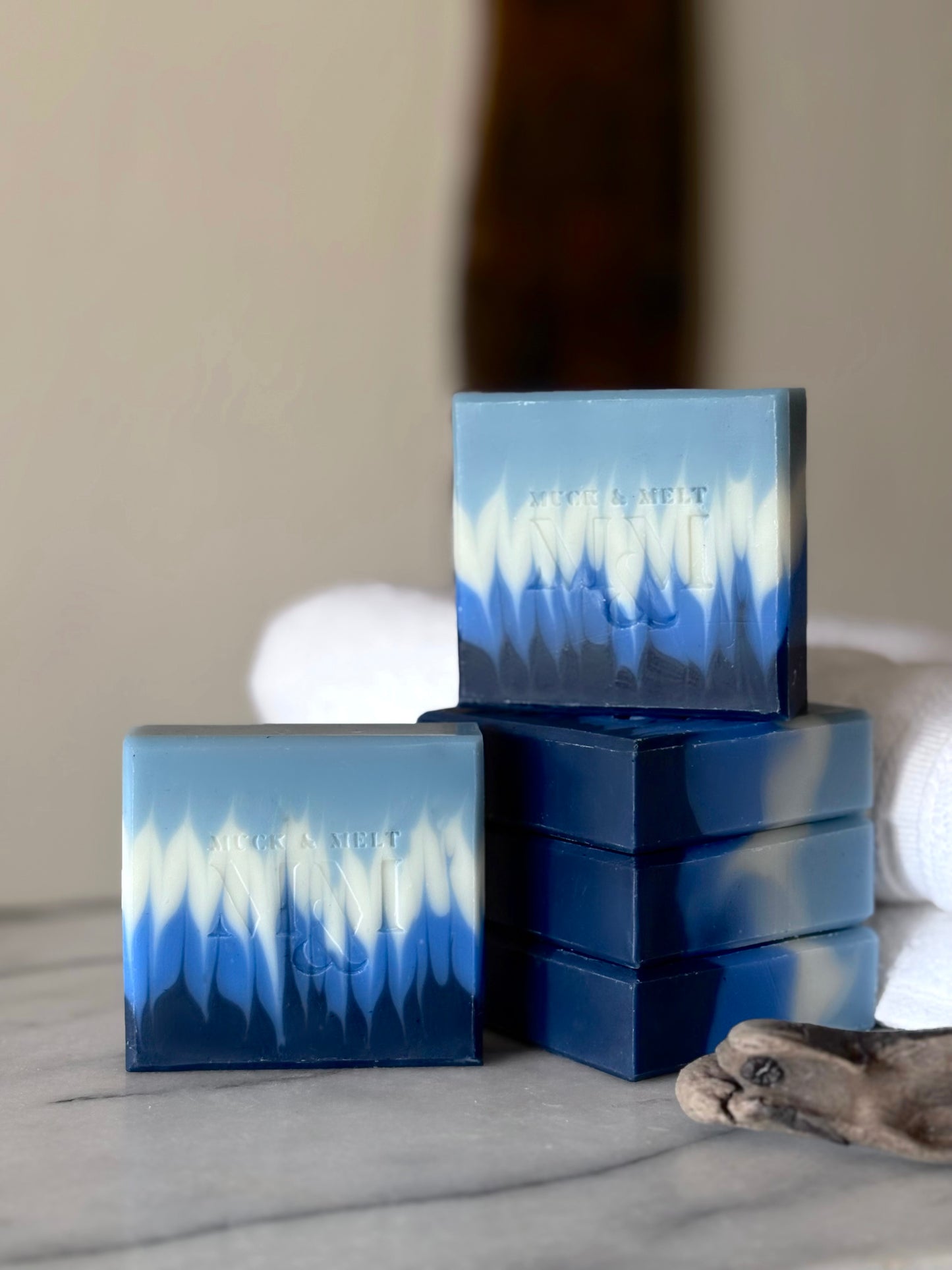 collection of Ocean-inspired natural handmade soap with deep blues and seafoam wave design