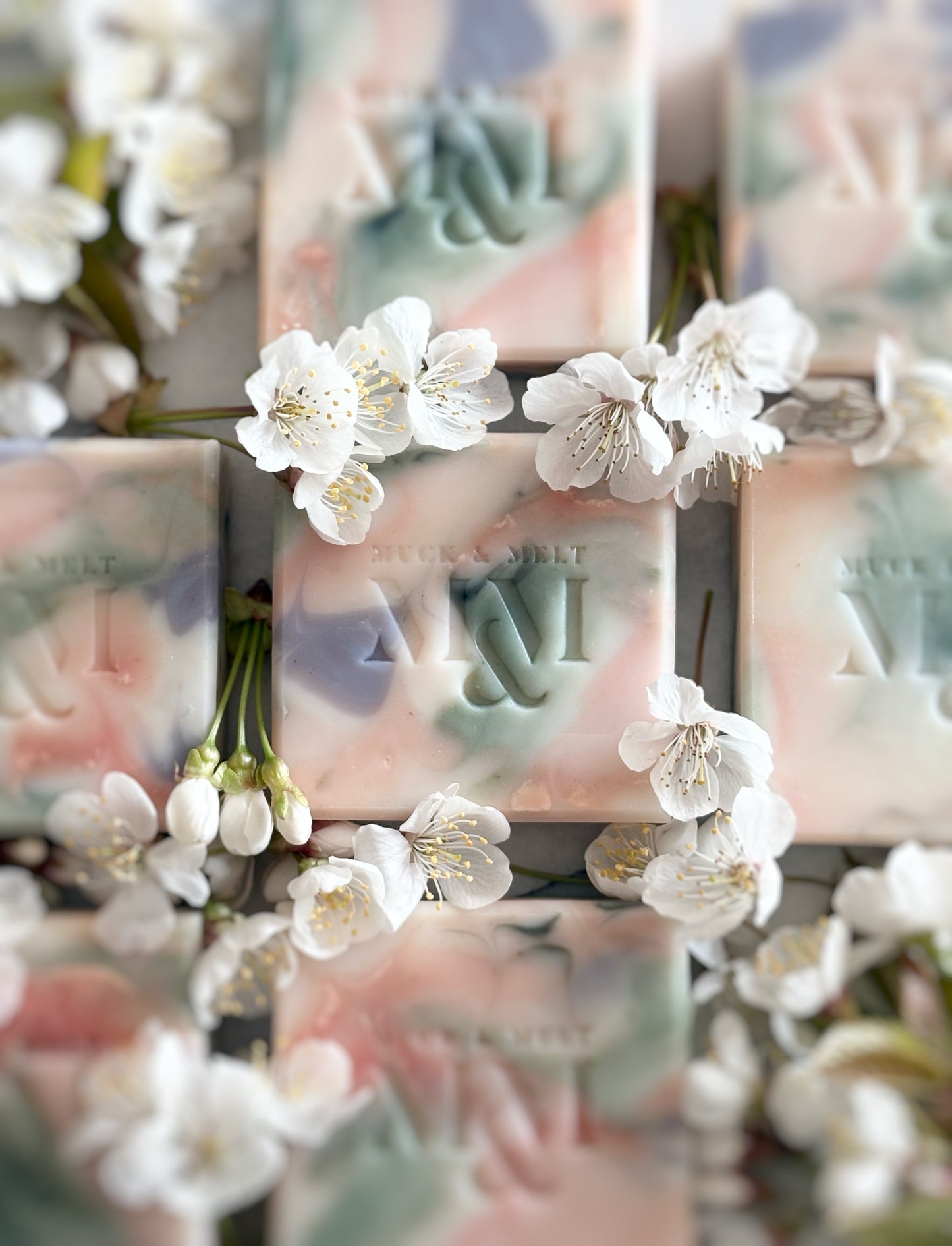 natural Artisan soap bar with floral-inspired swirls in natural pink, green, lilac and white hues with blossom flowers