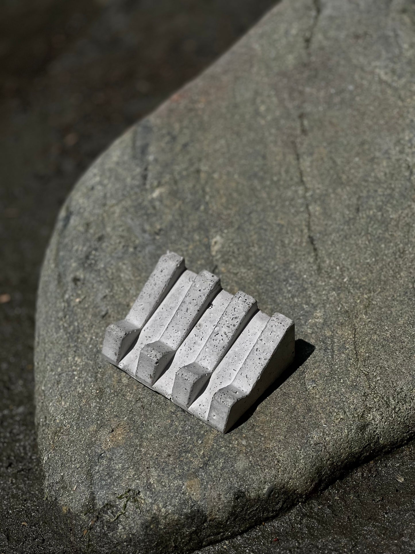 Handcrafted soap dish inspired by rugged rocks and raw textures on a rock