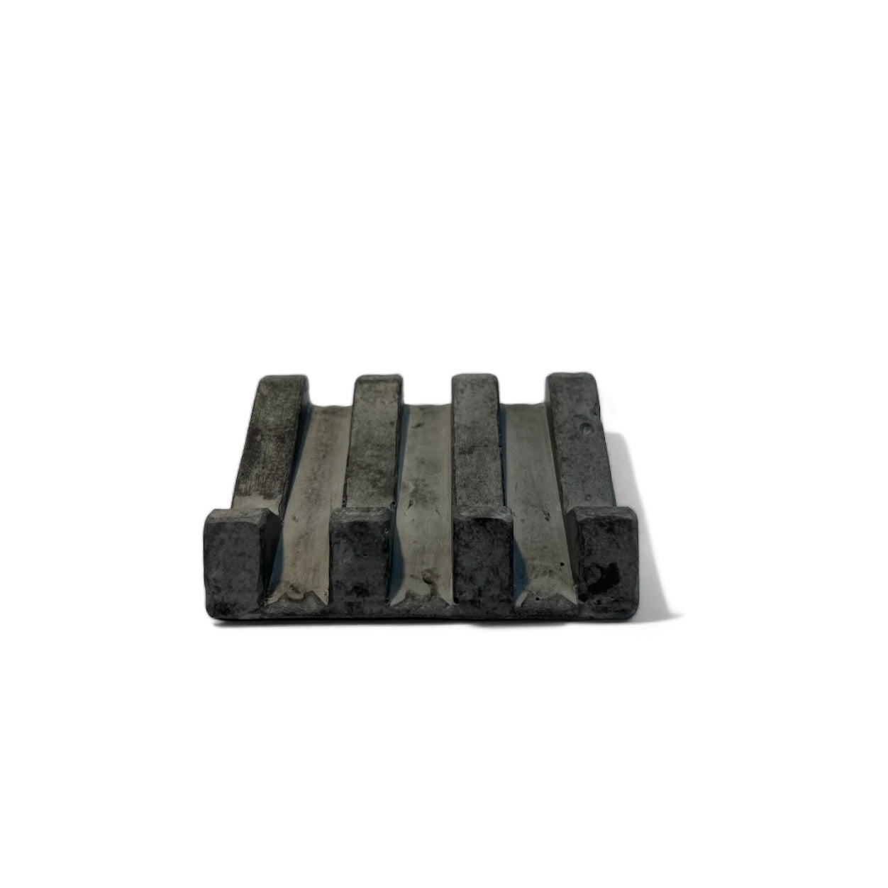 Black soap dish with organic design and slotted lines for drainage