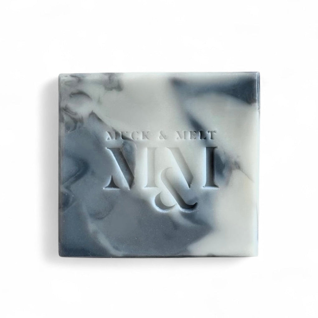 Handmade, natural artisan soap with rugged stone-inspired patterns in earthy tones