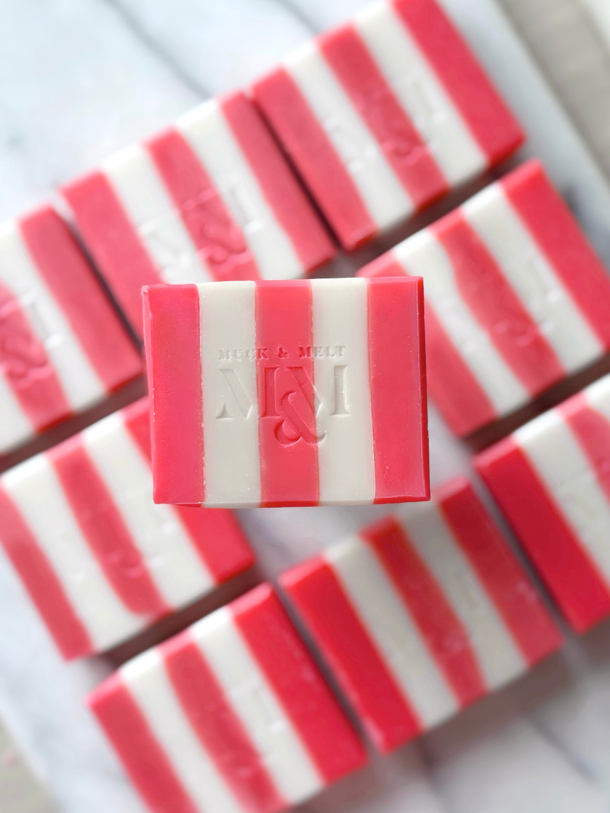 Pink and white striped soap bars with a brand logo on a white background. Best Valentines day gift for her.