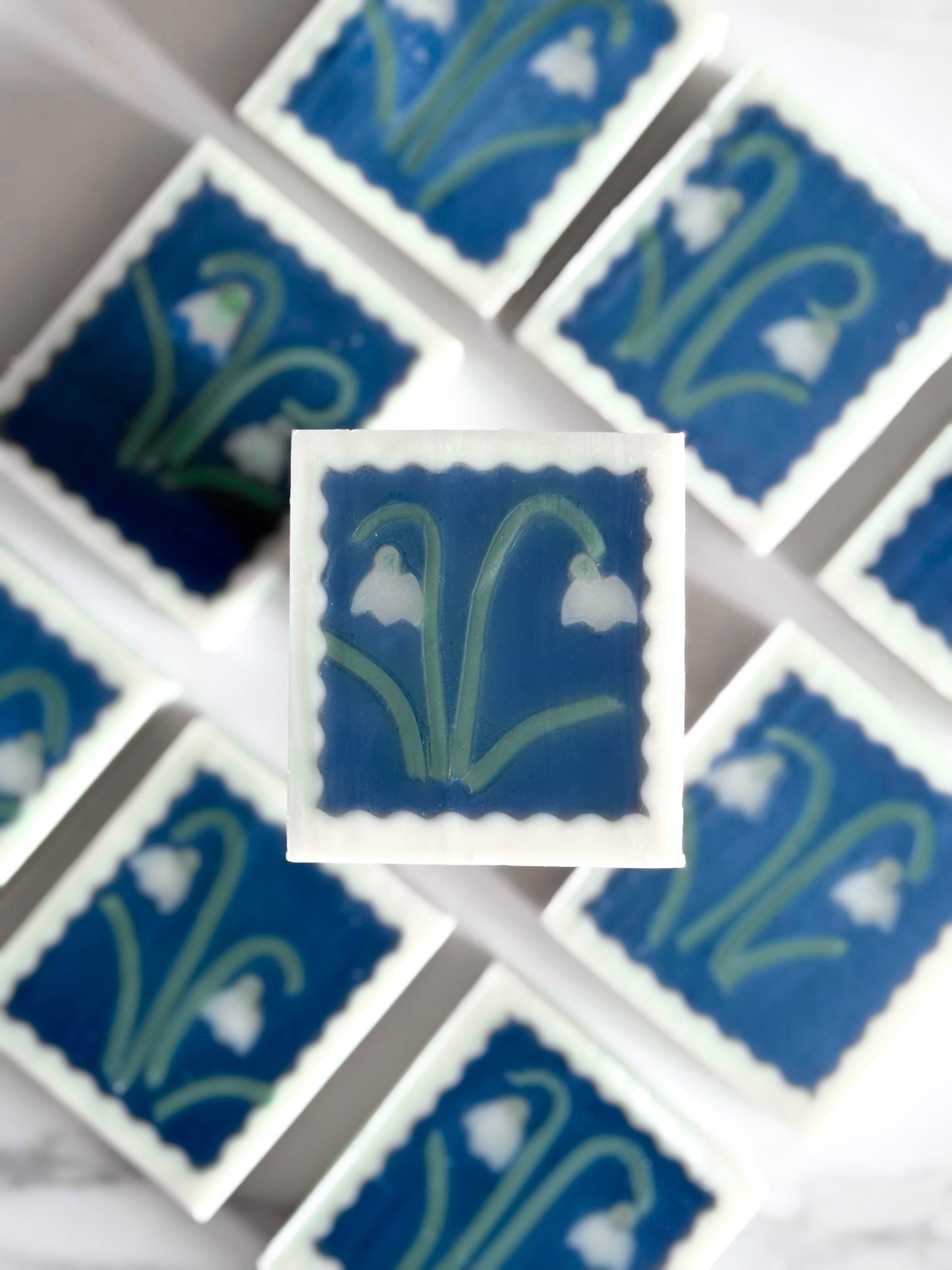 collection of handmade artisan soap featuring snowdrop flower motifs