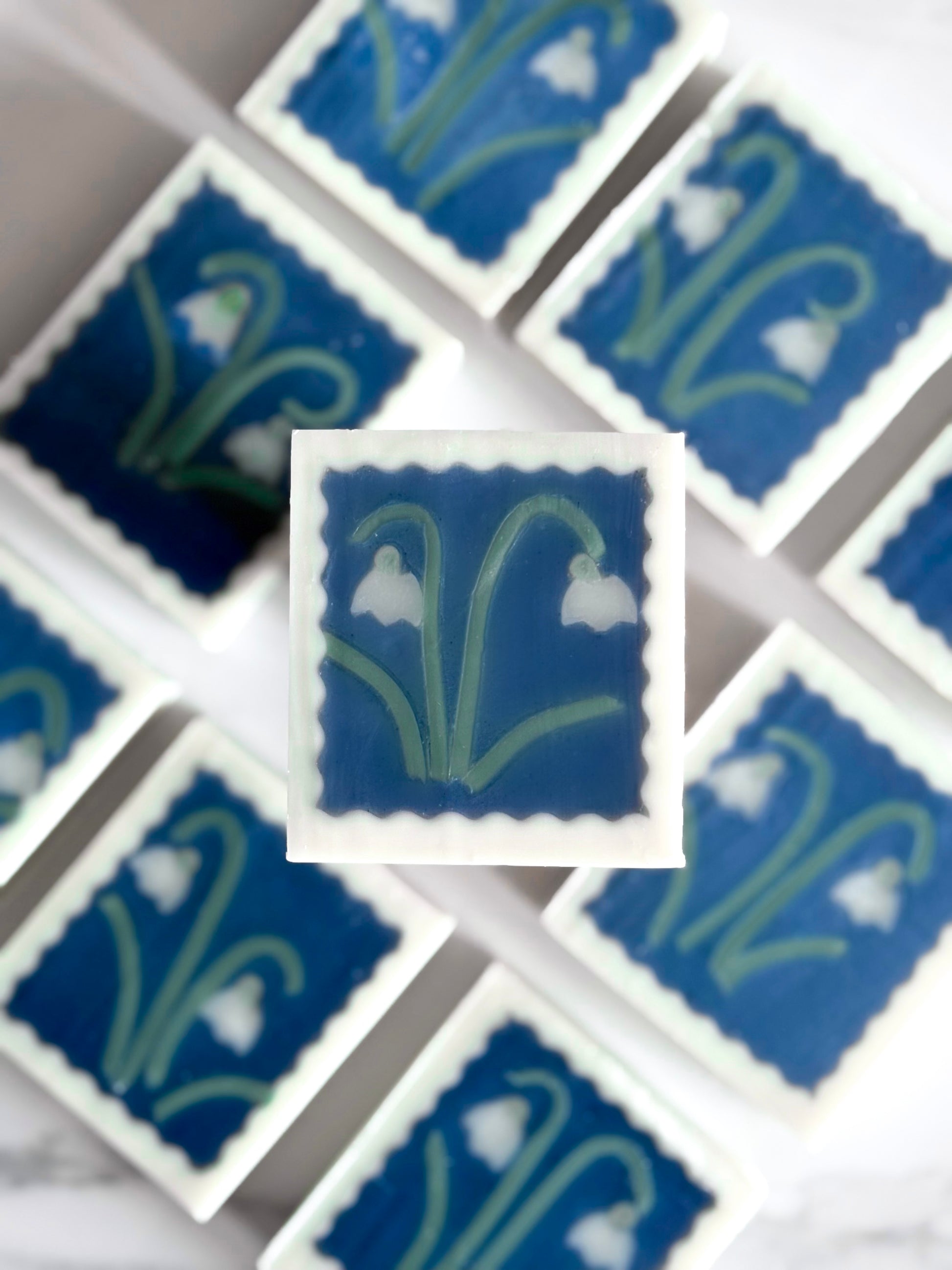 collection of handmade artisan soap featuring snowdrop flower motifs