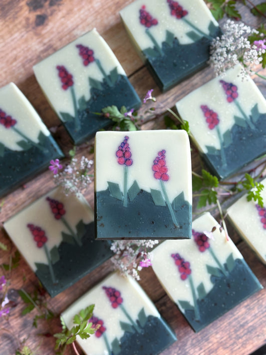 9 foxglove soaps on a table with woodland flowers