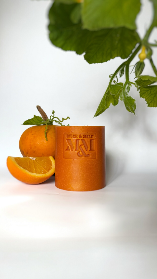 a bright orange natural handmade pumpkin soap bar with orange, neroli and black pepper essential oils.